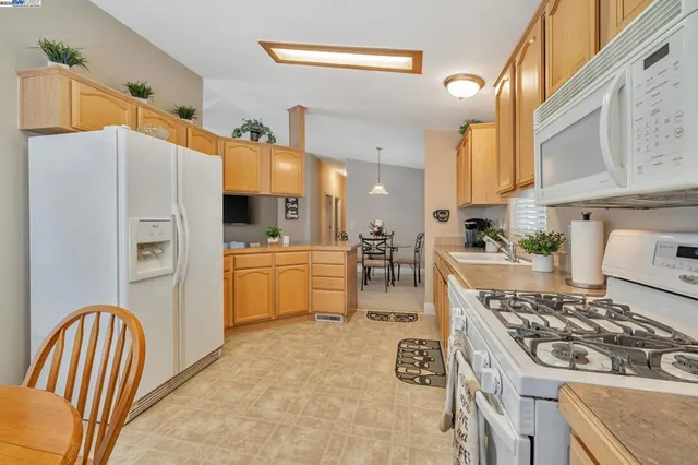 a kitchen with refrigerator a stove a sink and a cabinets