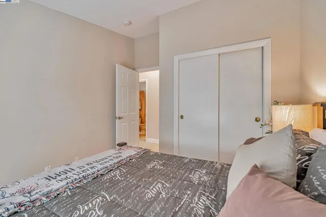 a bedroom with a bed and a closet