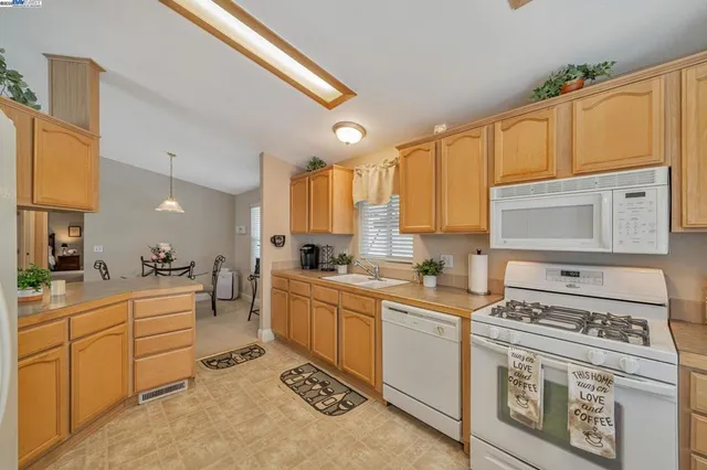 a kitchen with a stove a sink and cabinets