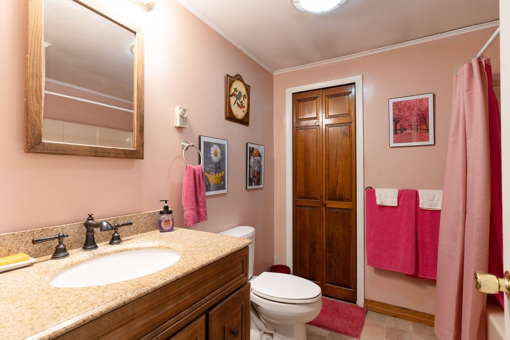 116 B Spencer Road Oakham, MA 01068 - Photo 13 of 22 a bathroom with a granite countertop toilet a sink and a mirror