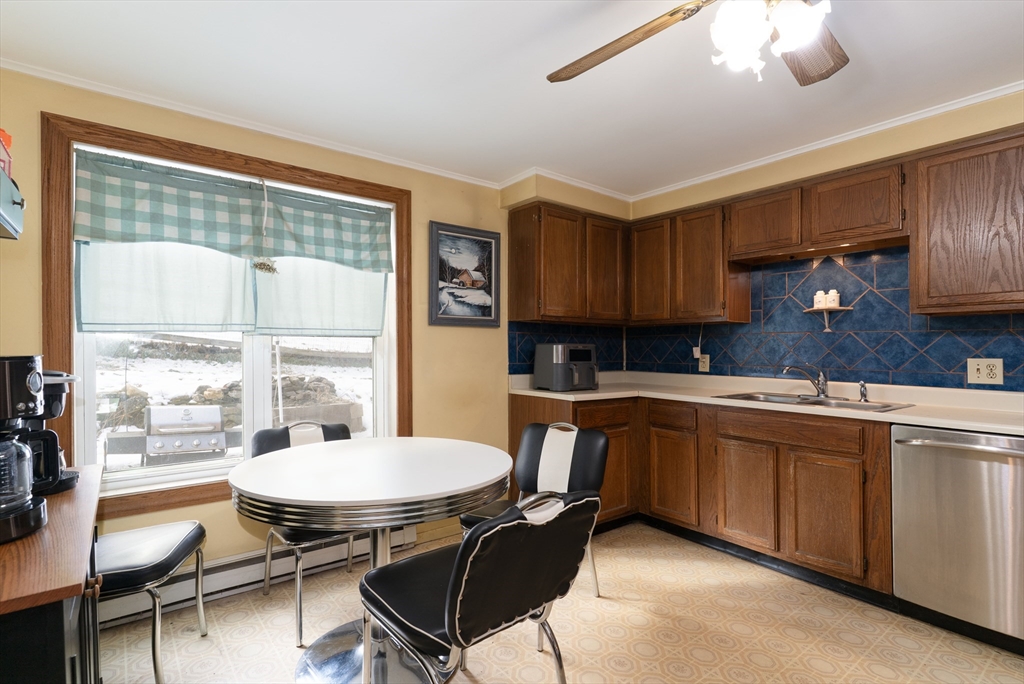 116 B Spencer Road Oakham, MA 01068 - Photo 16 of 22 a kitchen with a table chairs stove and cabinets