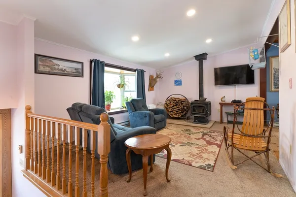 a living room with furniture a flat screen tv and a window