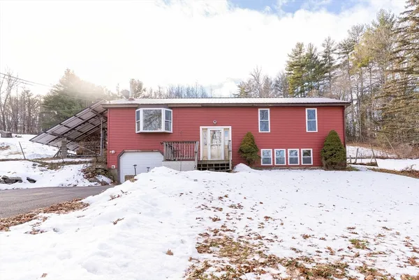 a view of a house with a yard covered in snow