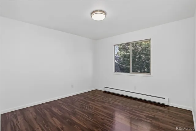 a view of an empty room with a fireplace