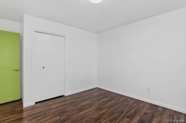 a view of a hallway with stainless steel appliances