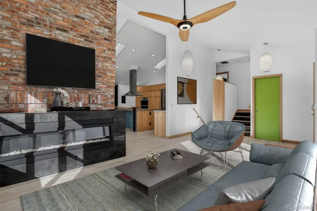 a view of a livingroom with furniture and a ceiling fan