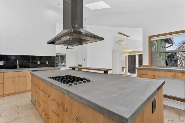 a kitchen with stainless steel appliances granite countertop a sink a refrigerator and a stove