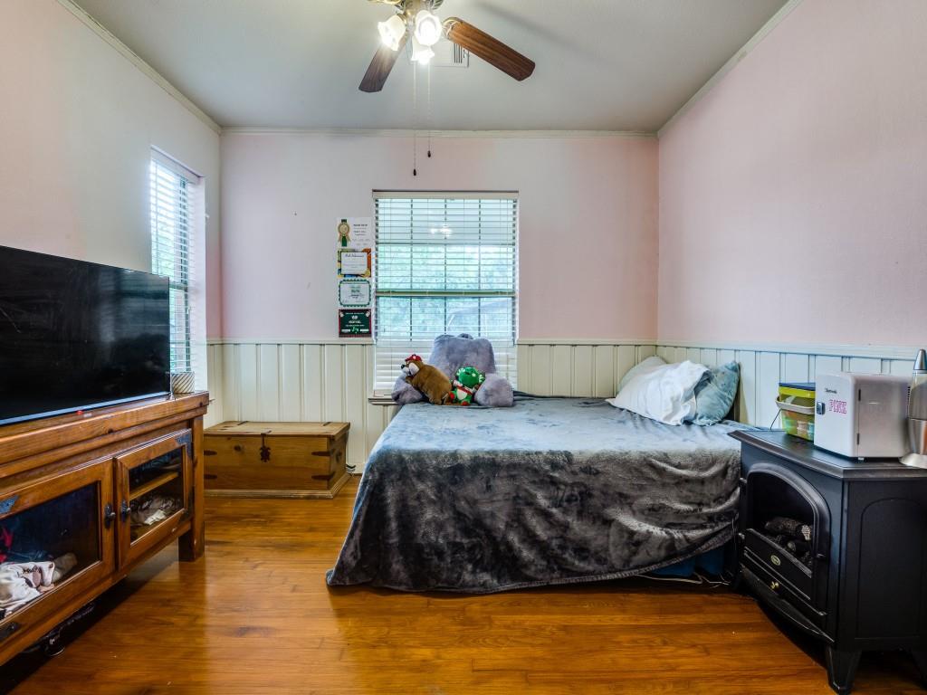111 County Road 2806 Mabank, TX 75147 - Photo 12 of 40 a bedroom with a bed and a flat screen tv