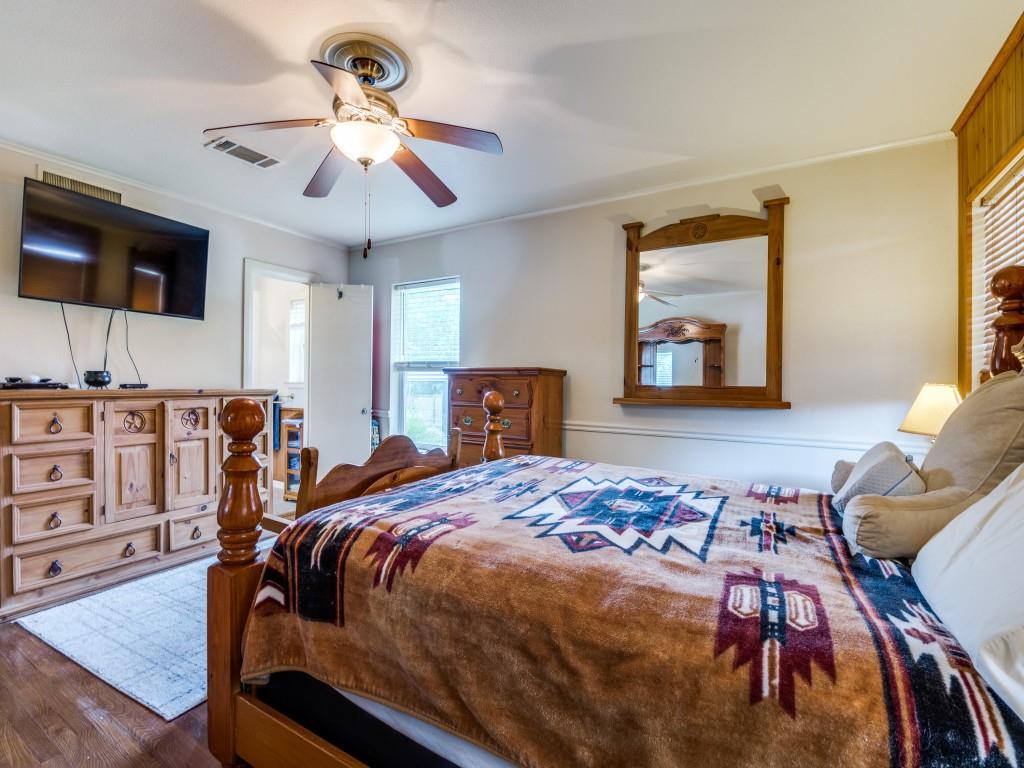 111 County Road 2806 Mabank, TX 75147 - Photo 17 of 40 a bedroom with bed and wooden floor