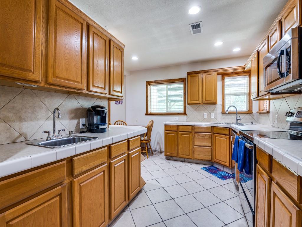 111 County Road 2806 Mabank, TX 75147 - Photo 35 of 40 a kitchen with stainless steel appliances granite countertop a sink stove and cabinets