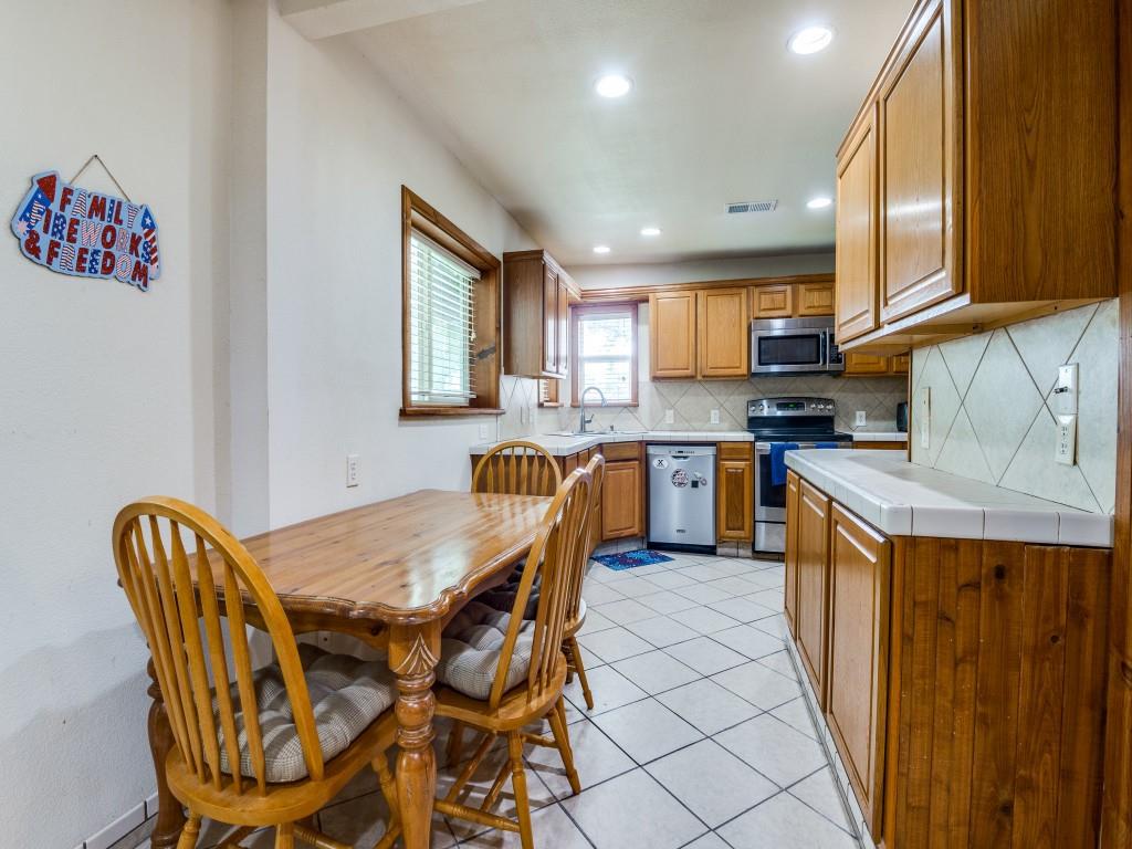 111 County Road 2806 Mabank, TX 75147 - Photo 38 of 40 a kitchen with stainless steel appliances granite countertop a kitchen island a table and chairs