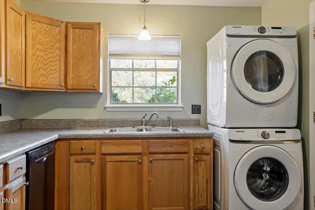 a utility room with sink dryer and washer