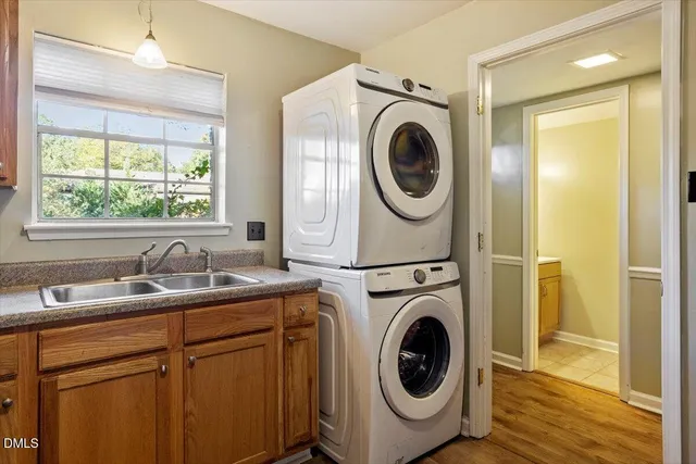 a utility room with sink dryer and washer