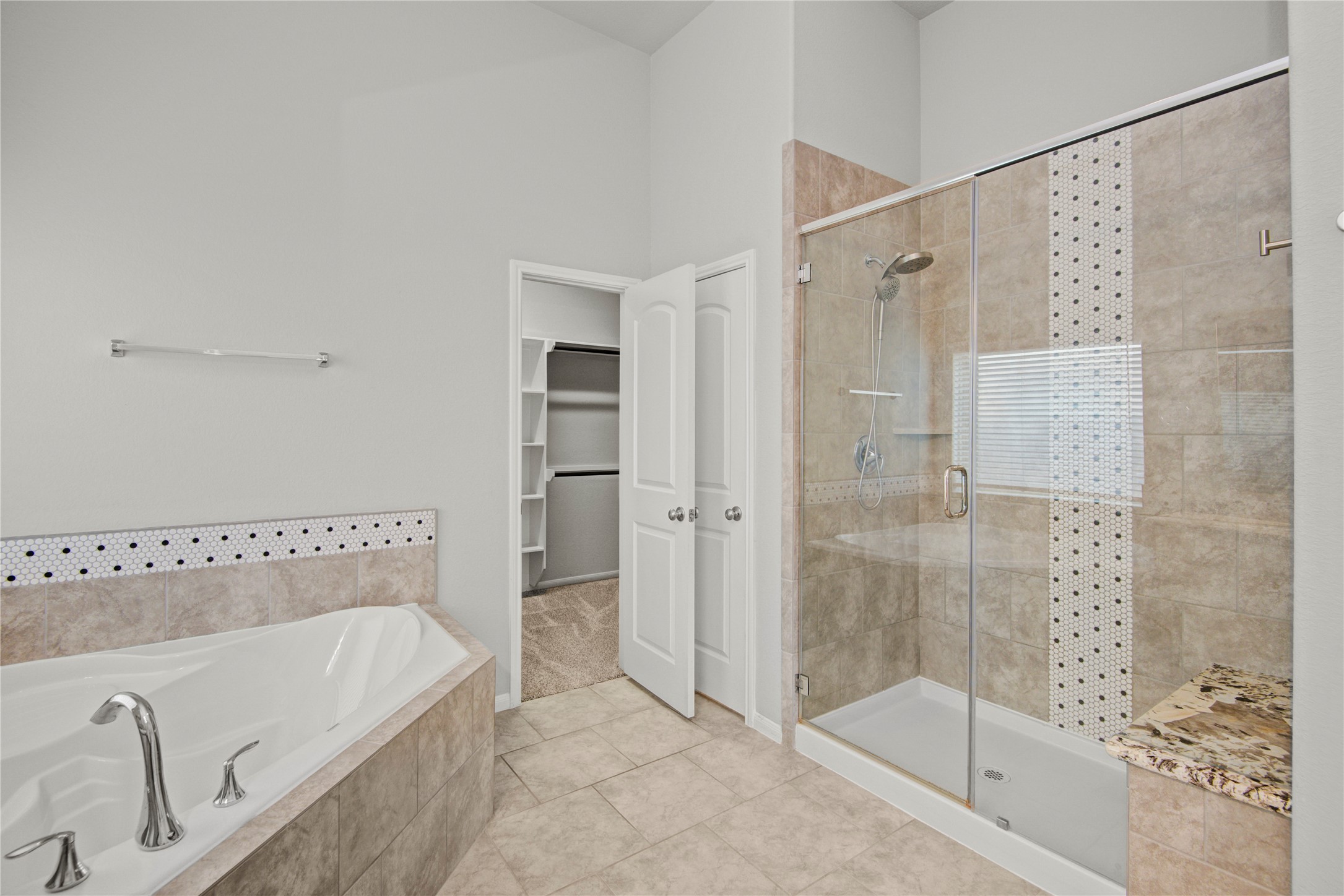 1314 Orchard Ridge Lane Tomball, TX 77375 - Photo 23 of 35 The ensuite bath includes a soaking tub, separate shower, and dual-sink vanity for a functional and comfortable design.