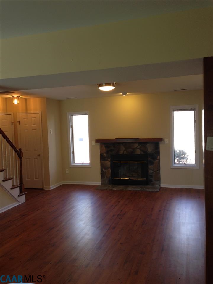 38 Colonial Road Palmyra, VA 22963 - Photo 2 of 8 an empty room with wooden floor fireplace and windows