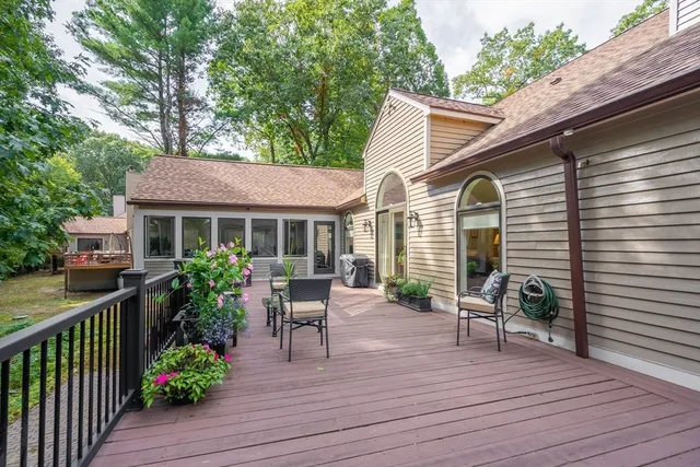 a view of house with patio outdoor seating and wooden floor