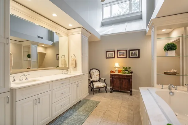 a spacious bathroom with a sink mirror and tub