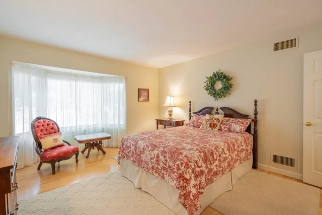 a bedroom with a bed and a chair