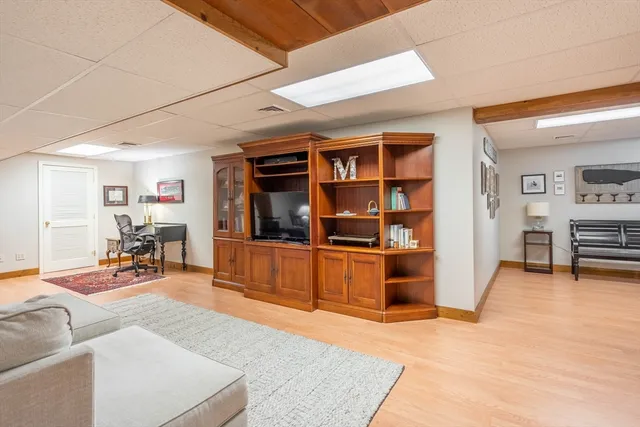 a living room with furniture and a book shelf