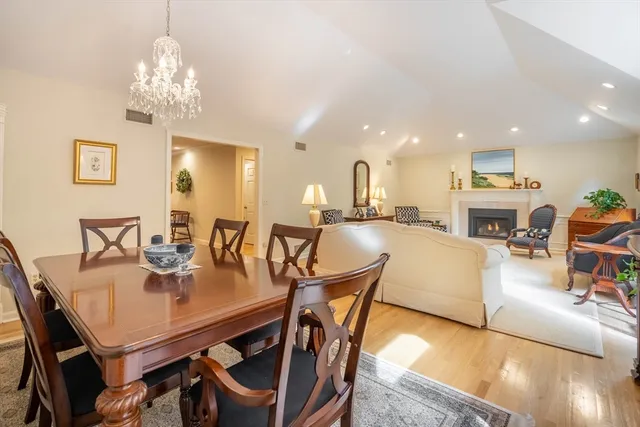 a view of a dining room with furniture and a chandelier