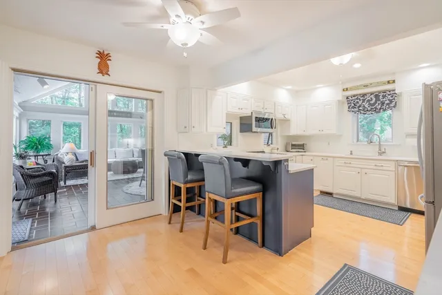 a kitchen with kitchen island a dining table and chairs