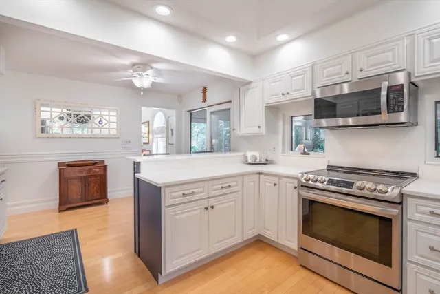 a kitchen with stainless steel appliances granite countertop a stove top oven a sink dishwasher a refrigerator and a stove