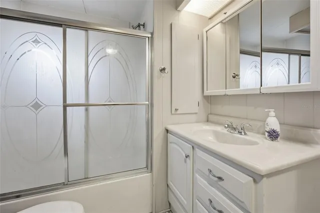 a bathroom with a sink a vanity and a mirror