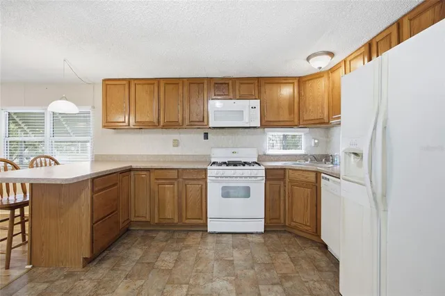 a kitchen with a white cabinets and white appliances