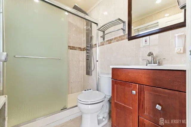 a bathroom with a toilet a sink and shower