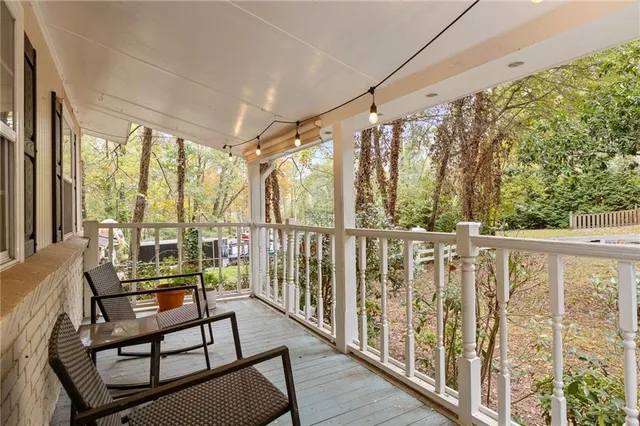 a view of a porch with furniture and wooden deck