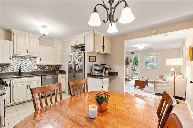 a large kitchen with a table and chairs