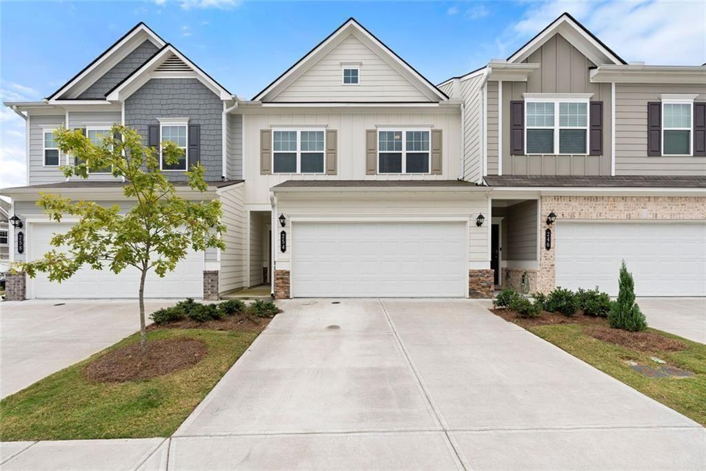 a front view of a house with a yard and garage