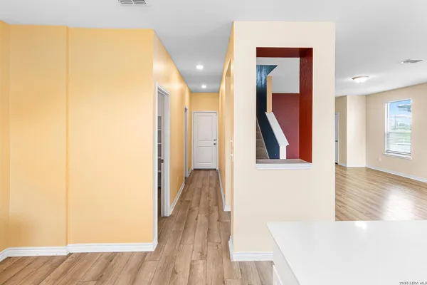 a view of hallway with wooden floor