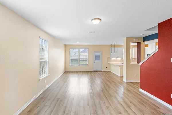 a view of a room with wooden floor and window