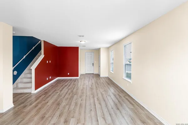a view of an empty room and wooden floor