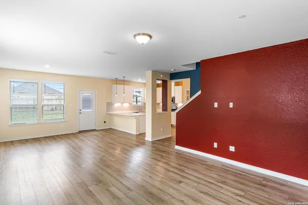 a view of a livingroom with wooden floor and windows