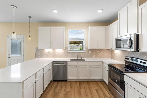 a kitchen with a sink stove and cabinets