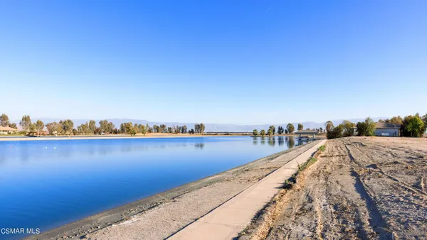 a view of a lake with chairs
