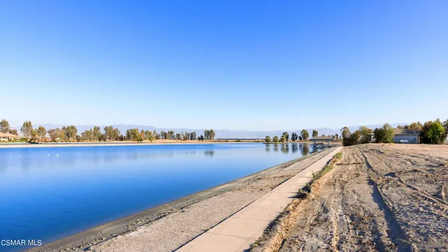 a view of a lake with chairs