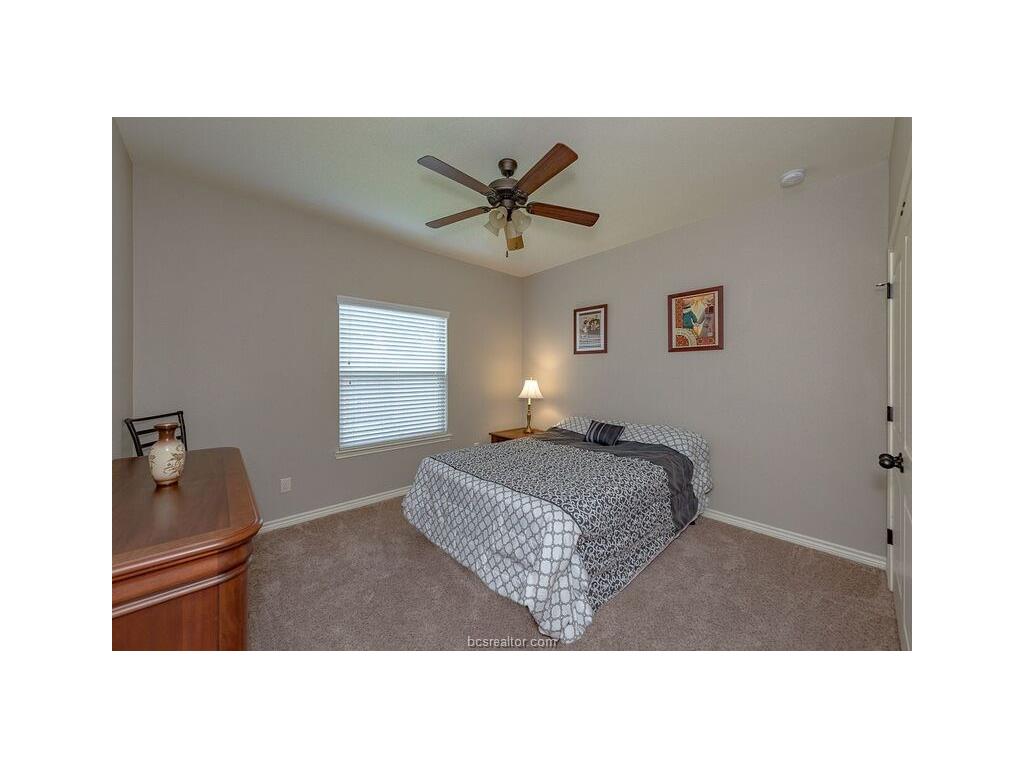 131 Watson Lane Bryan, TX 77801 - Photo 13 of 20 Carpeted bedroom with ceiling fan