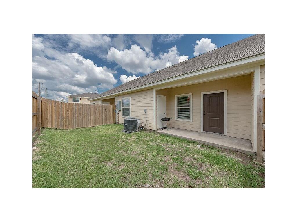 131 Watson Lane Bryan, TX 77801 - Photo 20 of 20 Rear view of property featuring a yard and central AC
