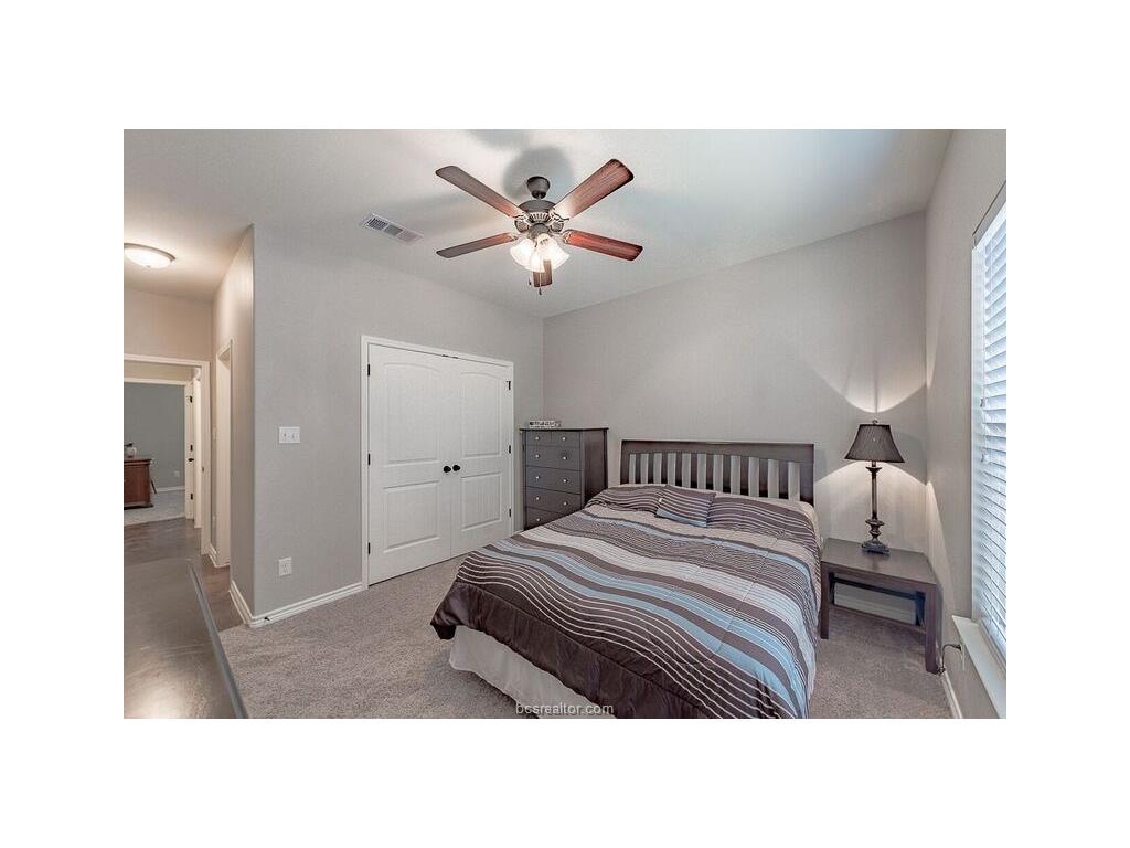 131 Watson Lane Bryan, TX 77801 - Photo 8 of 20 Carpeted bedroom with ceiling fan and a closet