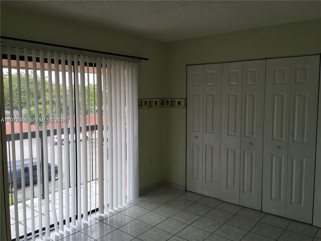 2162 West 60th Street, Unit 14208 Hialeah, FL 33016 - Photo 7 of 10 a view of an empty room with wooden floor