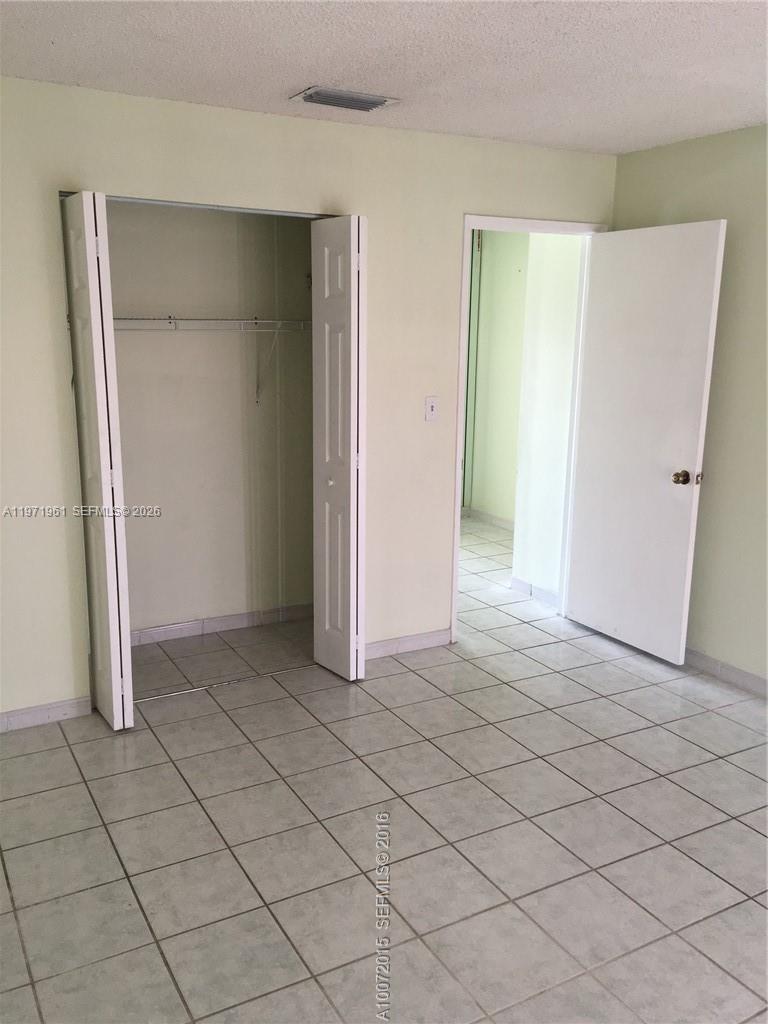 2162 West 60th Street, Unit 14208 Hialeah, FL 33016 - Photo 8 of 10 an empty room with windows