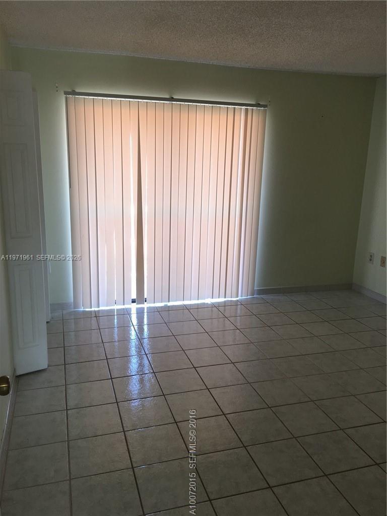2162 West 60th Street, Unit 14208 Hialeah, FL 33016 - Photo 9 of 10 an empty room with a window