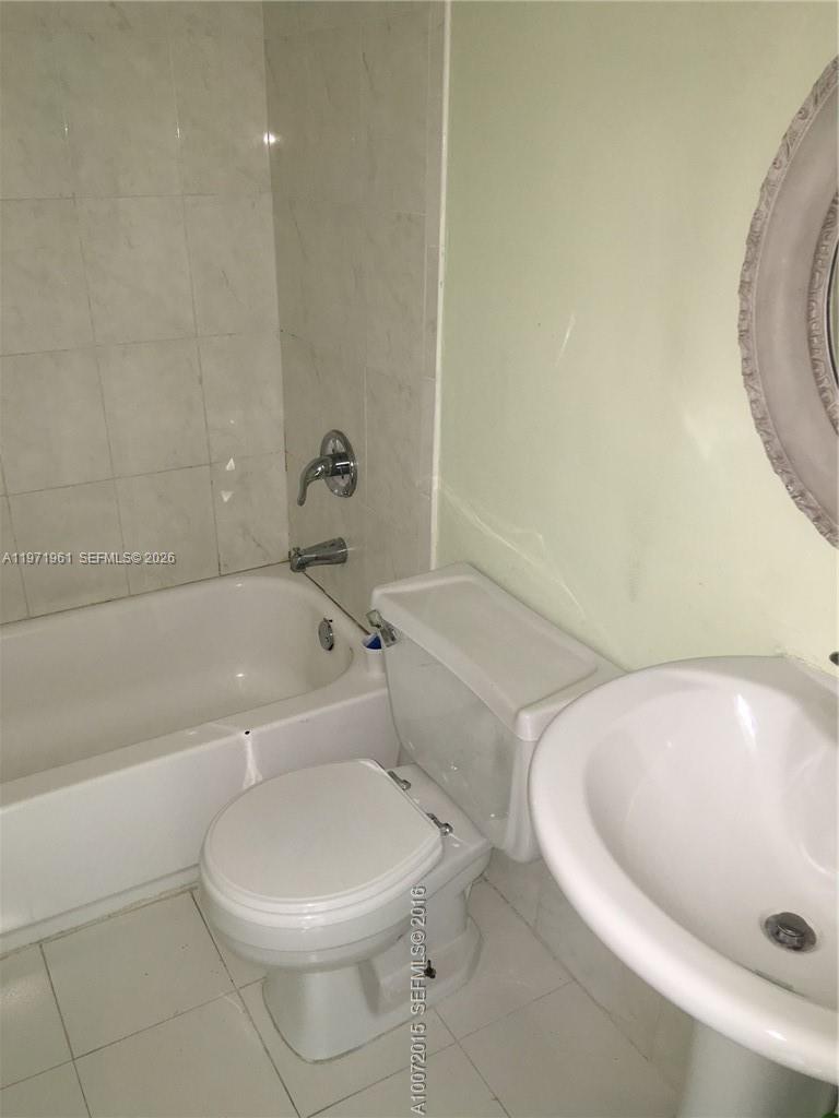2162 West 60th Street, Unit 14208 Hialeah, FL 33016 - Photo 10 of 10 a bathroom with a toilet and bathtub