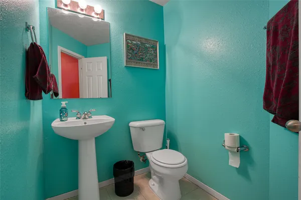 a bathroom with a sink mirror and toilet