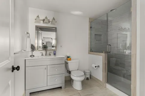 a bathroom with a sink toilet and shower