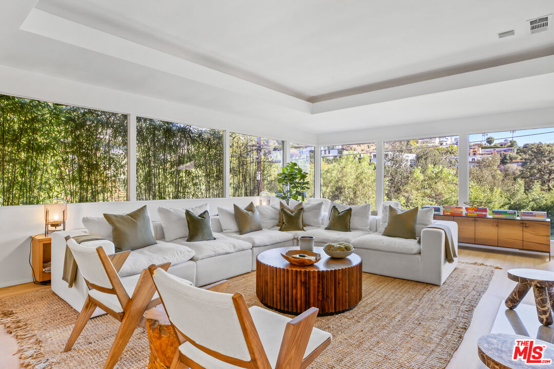 a living room with furniture and a large window