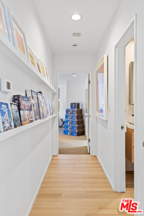 9271 Flicker Way Los Angeles, CA 90069 - Photo 15 of 28 a view of a hallway with wooden floor and stairs